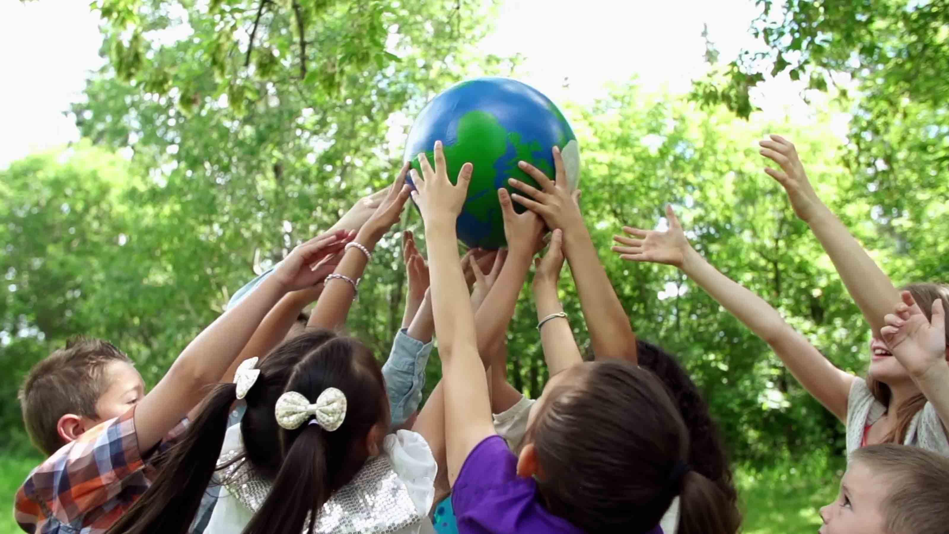 Children holding globe together