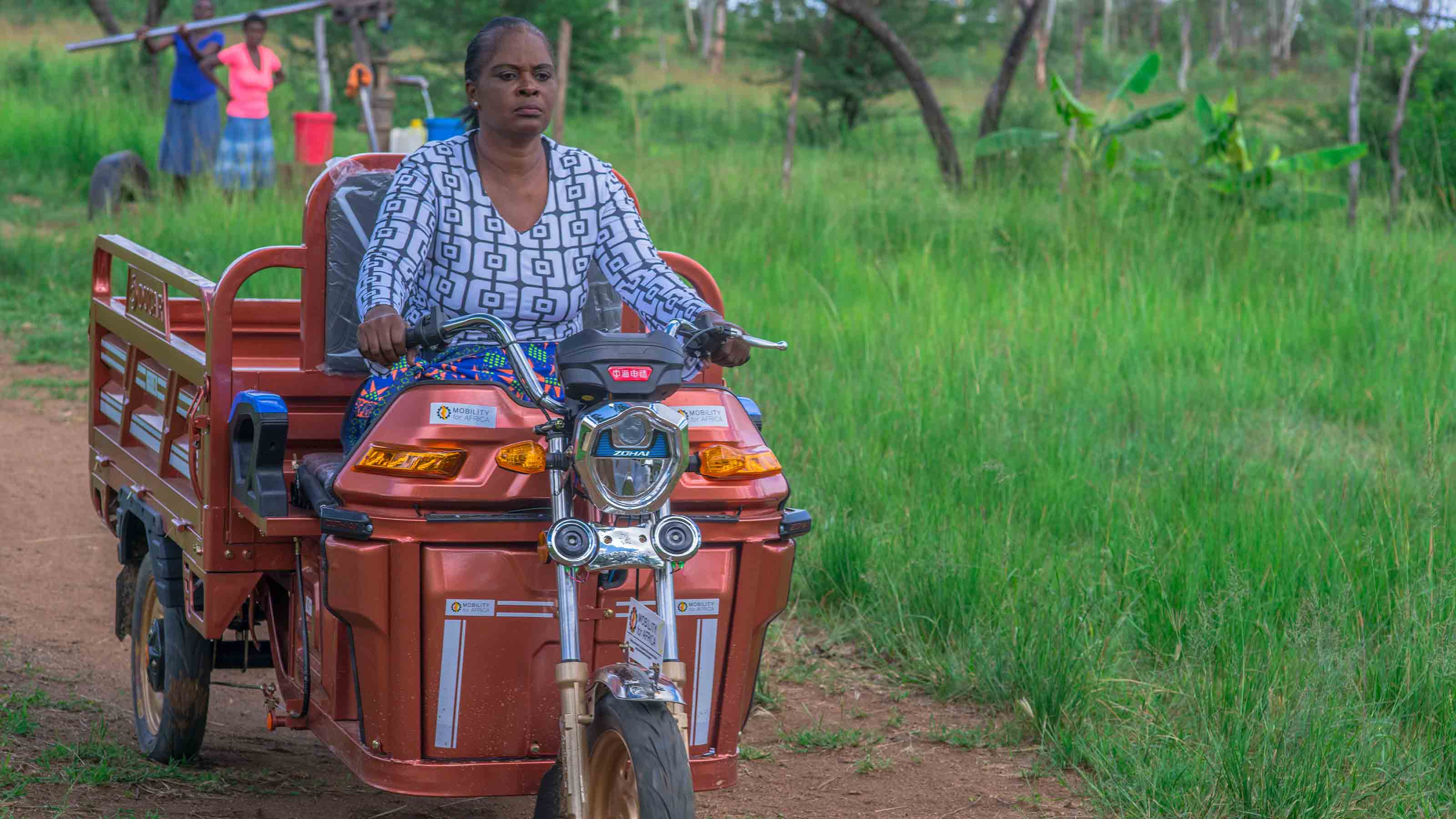 Zimbabwean woman driving tricycle 