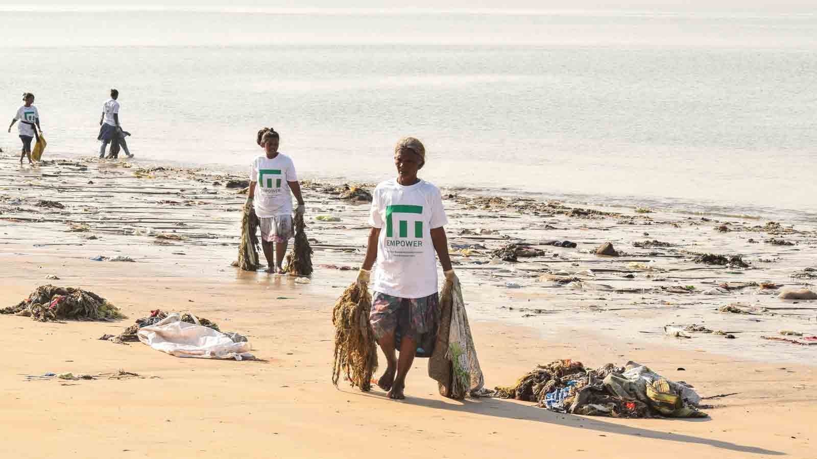 Ladies picking up garbage at the beach