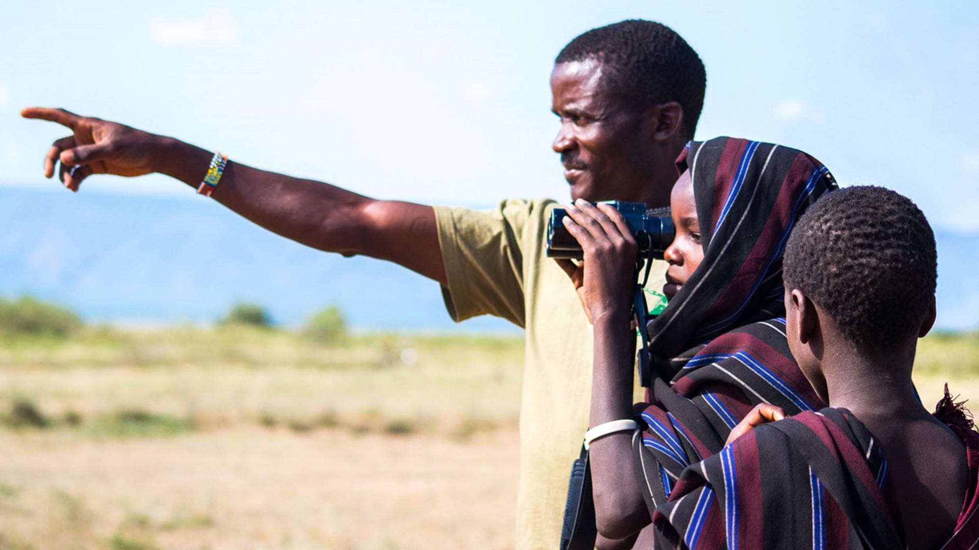 Locals from Tanzania looking through binoculars in the Mbulu District 